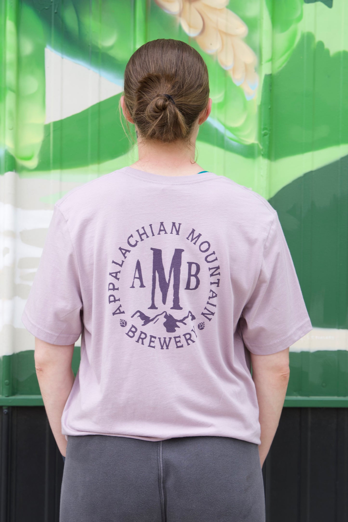 View of back of dusty purple Appalachian Mountain Brewery t-shirt