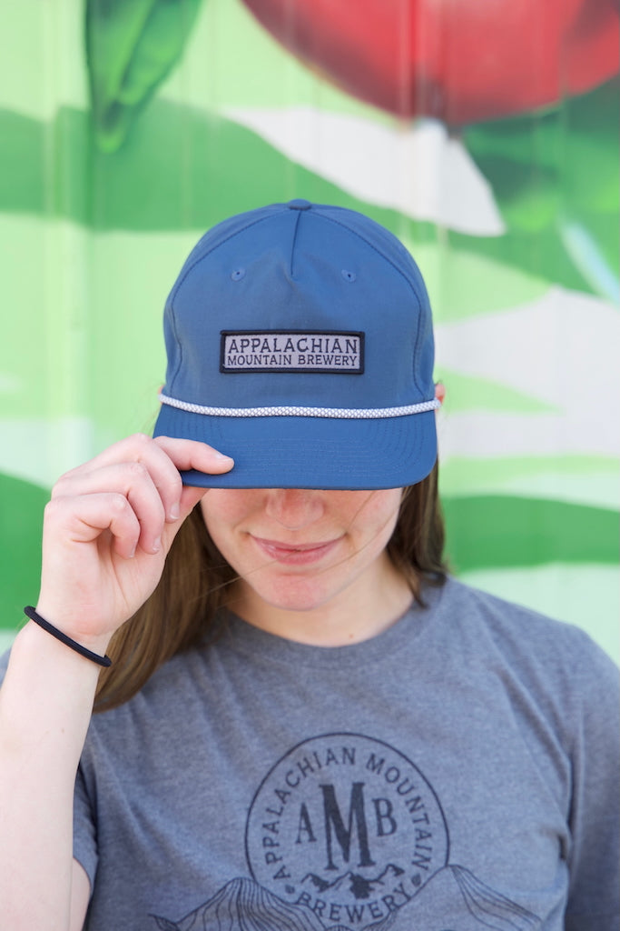Person wearing Appalachian Mountain 5-panel blue snapback hat