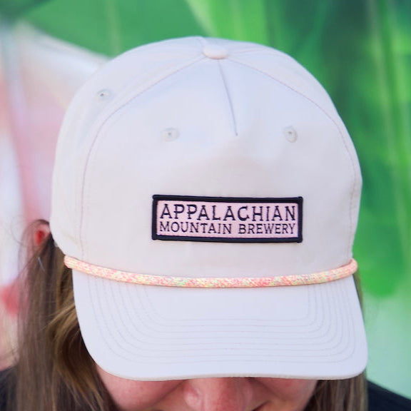 Person wearing Appalachian Mountain 5-panel cream snapback hat