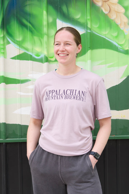 Person wearing dusty purple Appalachian Mountain Brewery t-shirt