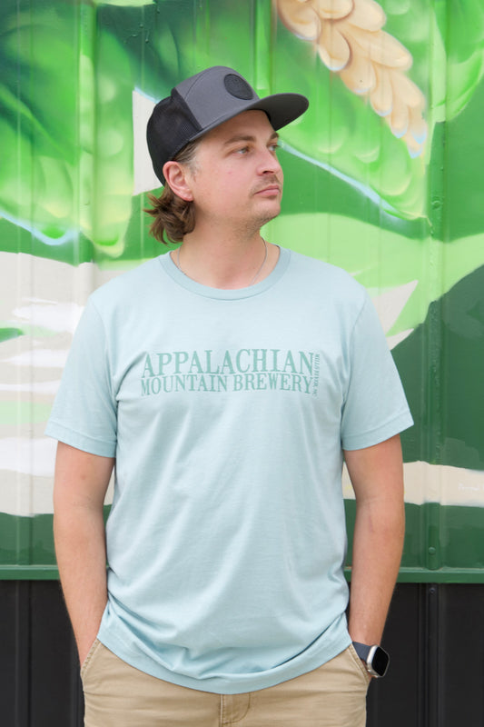 The front of the Dusty Blue AMB Logo T-shirt 